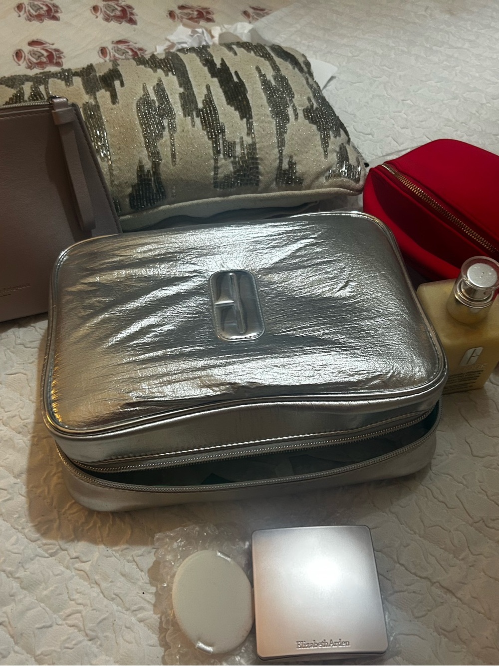 Clinique moisturizer & metallic travel bag plus Elizabeth Ard medium bronz.&bag